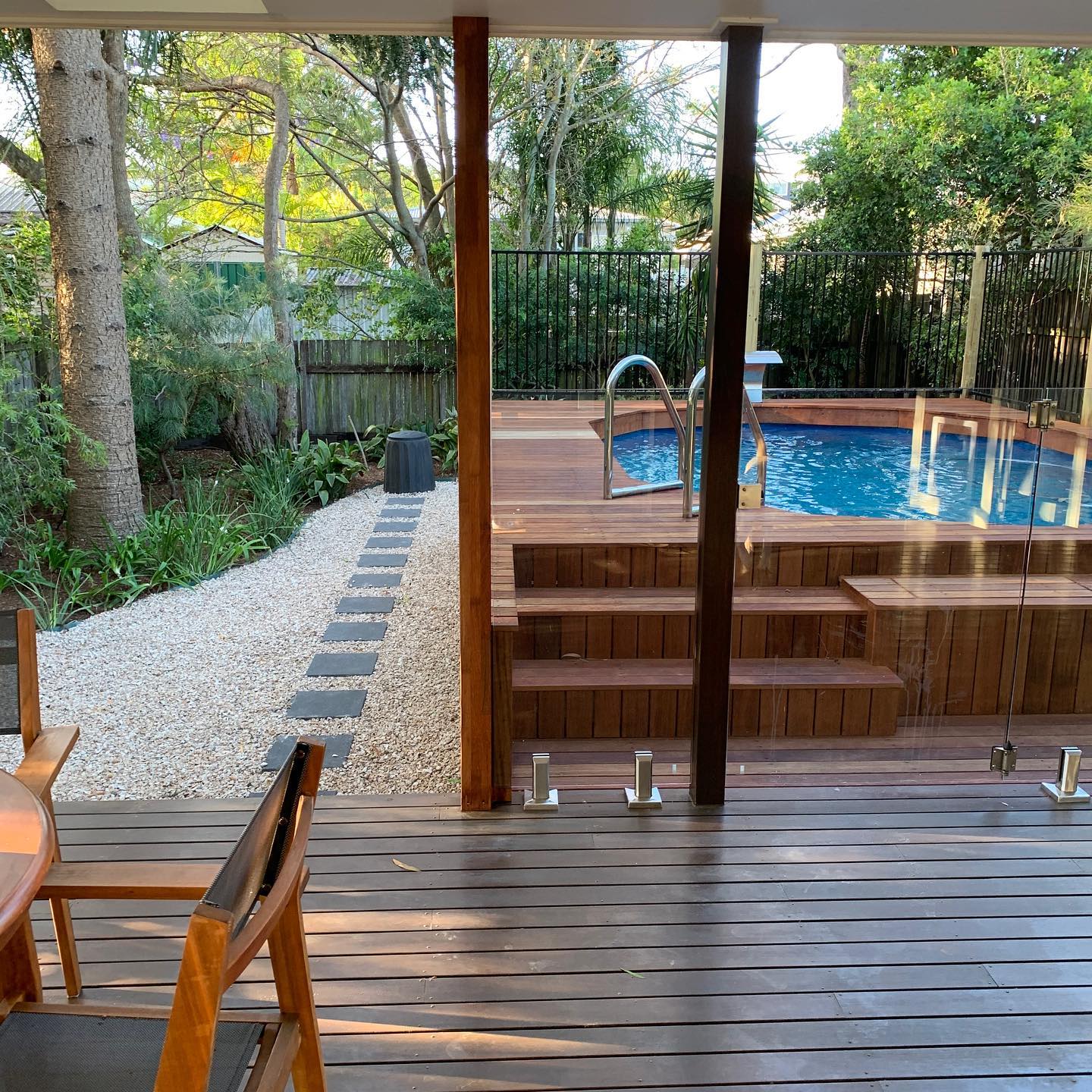 Timber deck with pool and pebble garden path in The Gap