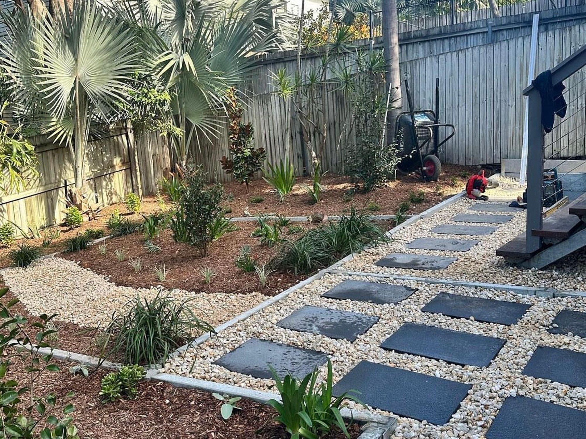 Backyard transformation with stepping stones and tropical plants in Paddington